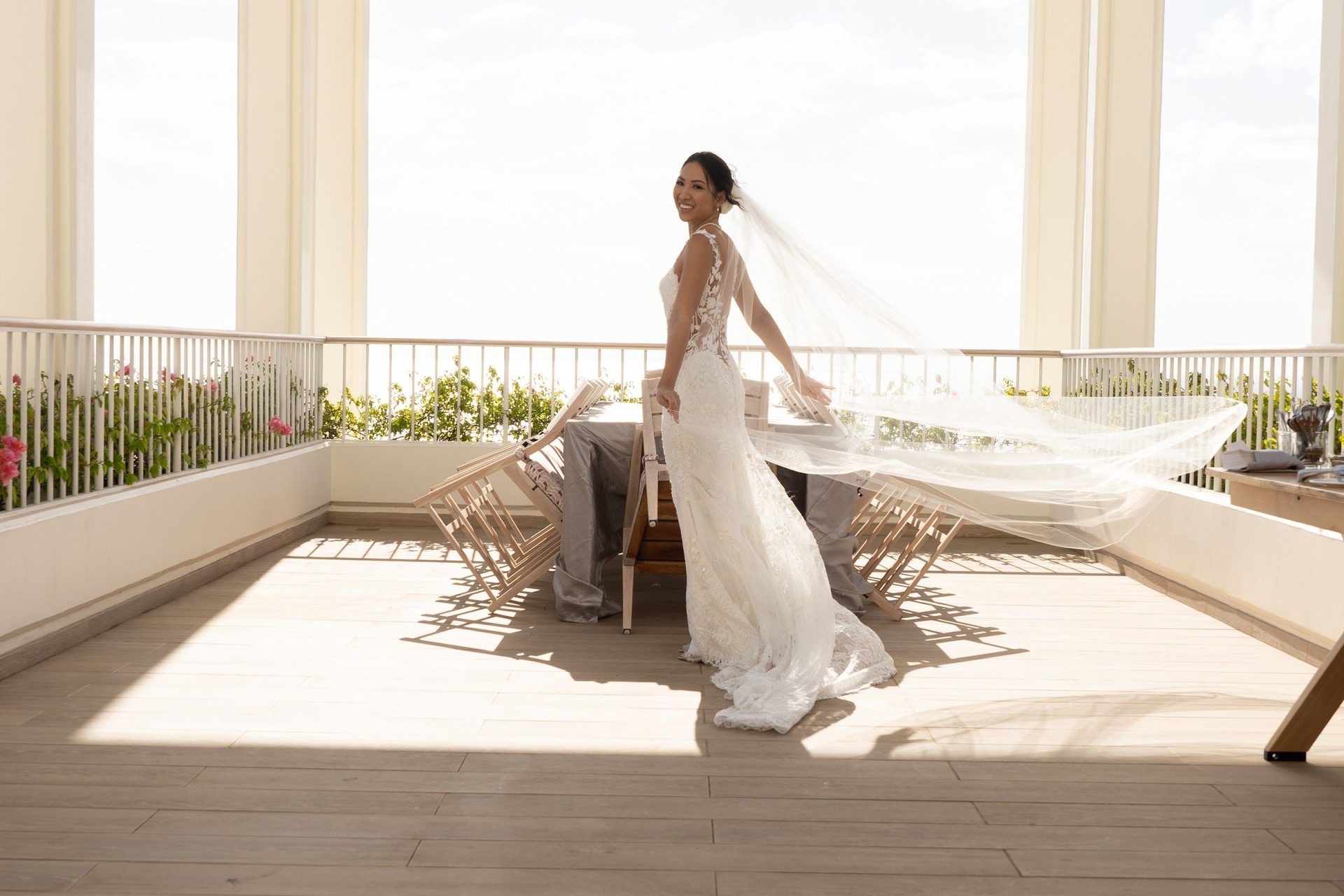 Bride walking through a bright interior toward the ceremony
