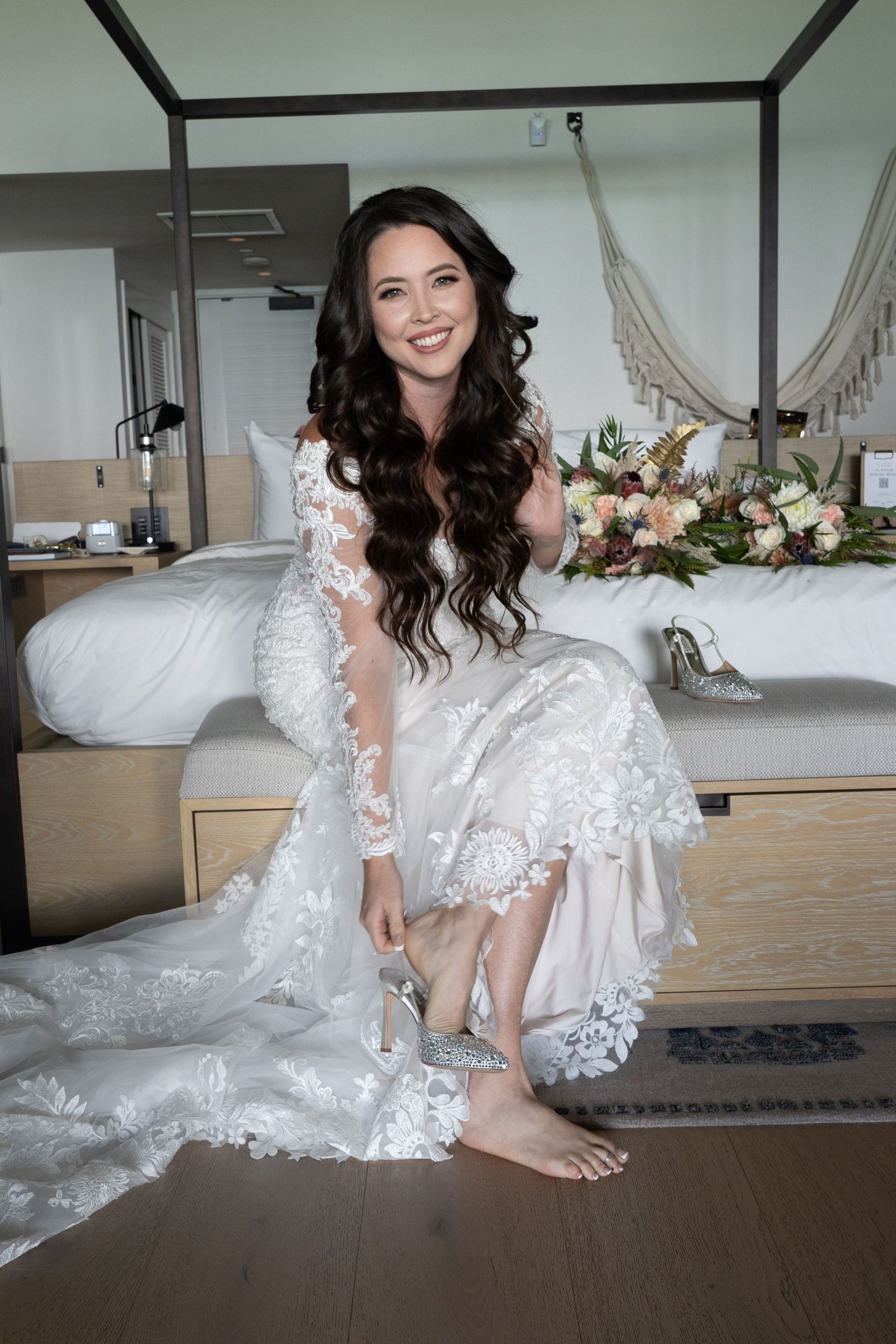 Bride seated in soft window light before the ceremony